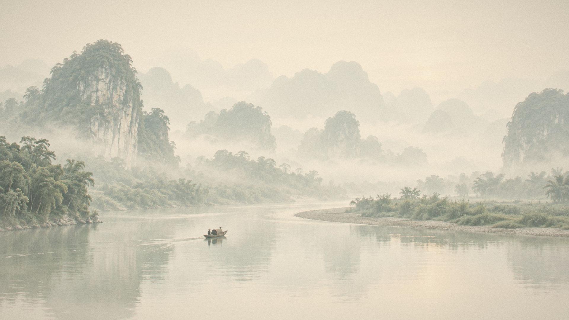 Blue-grey mist among limestone hills at dawn, layer behind layer like an ink painting, a river bend with one small wooden boat
